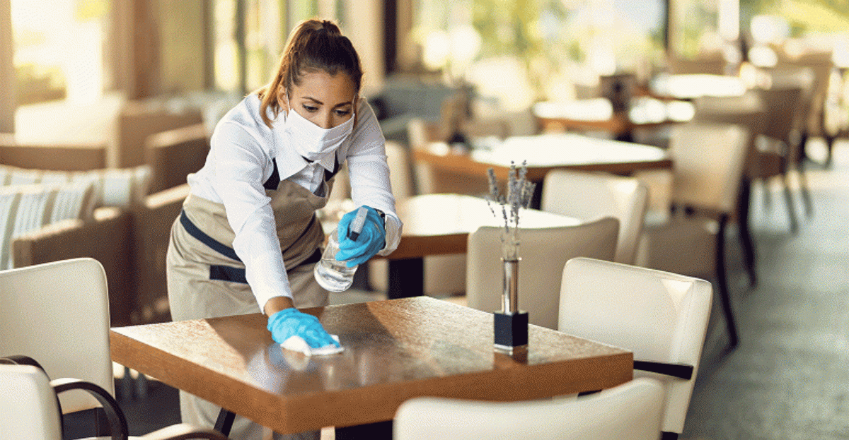 Waitress Cleaning A Restaurant Table