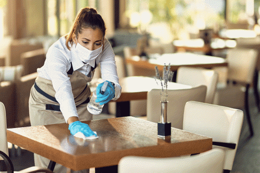 Waitress Cleaning A Restaurant Table